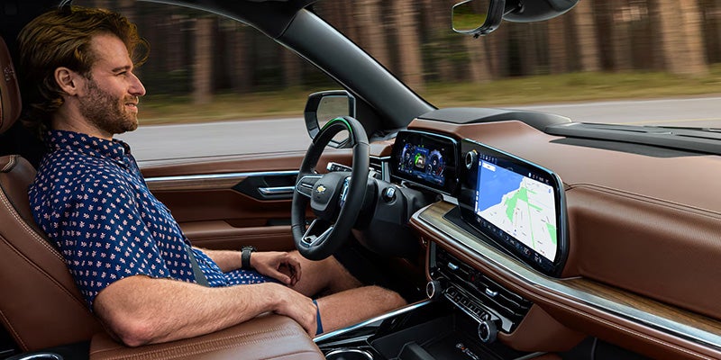 Driver inside vehicle using digital dashboard and navigation screen