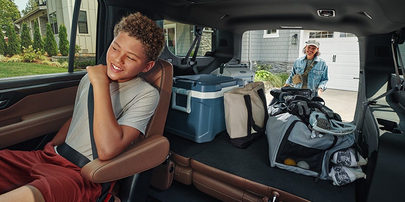 Vehicle interior with rear cargo area loaded with bags and gear