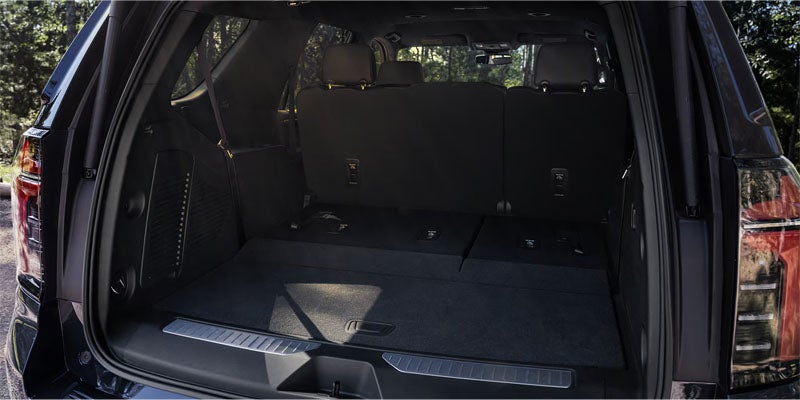Rear view of a vehicle's cargo area with all back seats folded down, showcasing a flat, spacious floor.