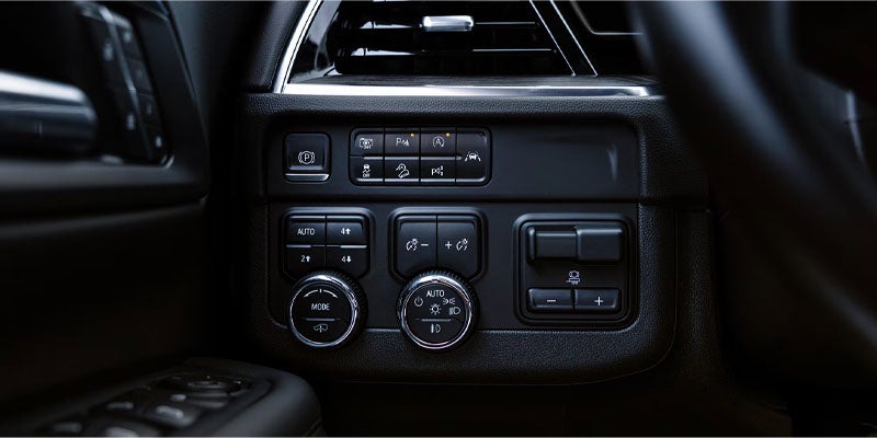 Car dashboard controls, including parking brake, 4x4 drive, lighting modes, and trailer brake settings.
