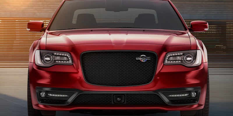 Red Chrysler sedan front grille view