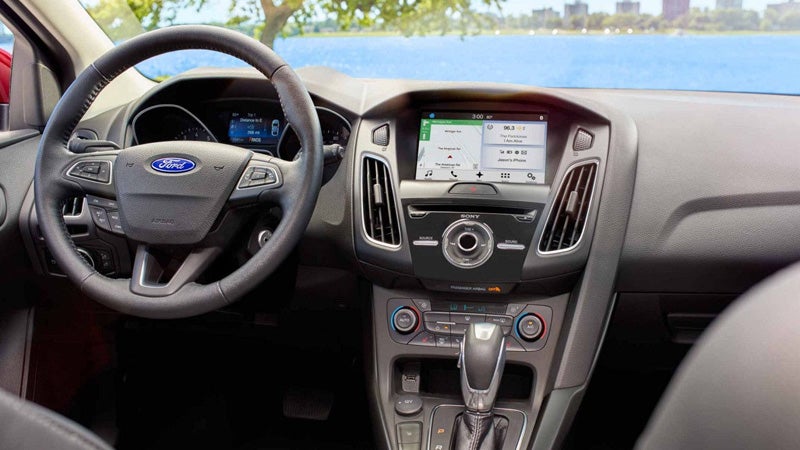 Ford Focus interior showing steering wheel, dashboard layout, and center console display
