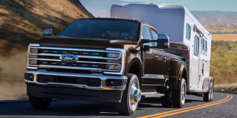 Ford F-350 towing trailer on highway