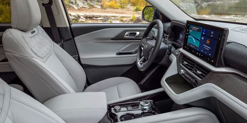 Light grey interior of a car with a modern dashboard and large touchscreen display.