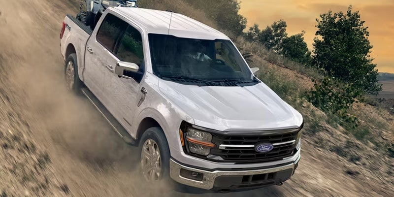 White Ford F-150 off-road on dirt trail