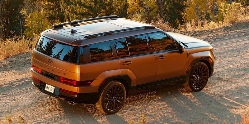 Hyundai Santa Fe SUV rear view on dirt road