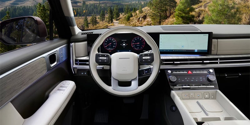 Modern vehicle dashboard with steering wheel and touchscreen display