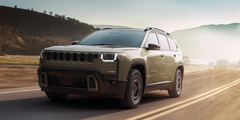 Jeep Cherokee SUV driving on a scenic road with modern rugged exterior design