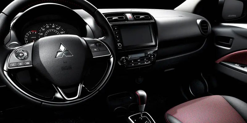 Car interior with steering wheel, dashboard, and display screen