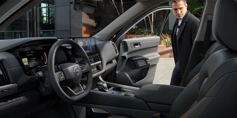 Nissan SUV, with the steering wheel, dashboard, and infotainment screen visible inside.