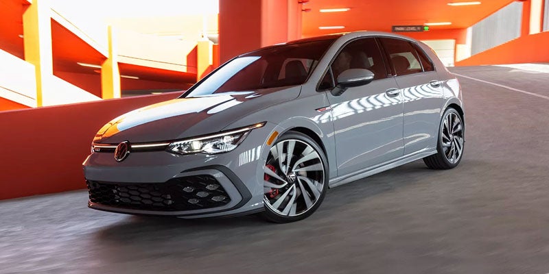 Grey Volkswagen Golf GTI parked in a modern parking structure